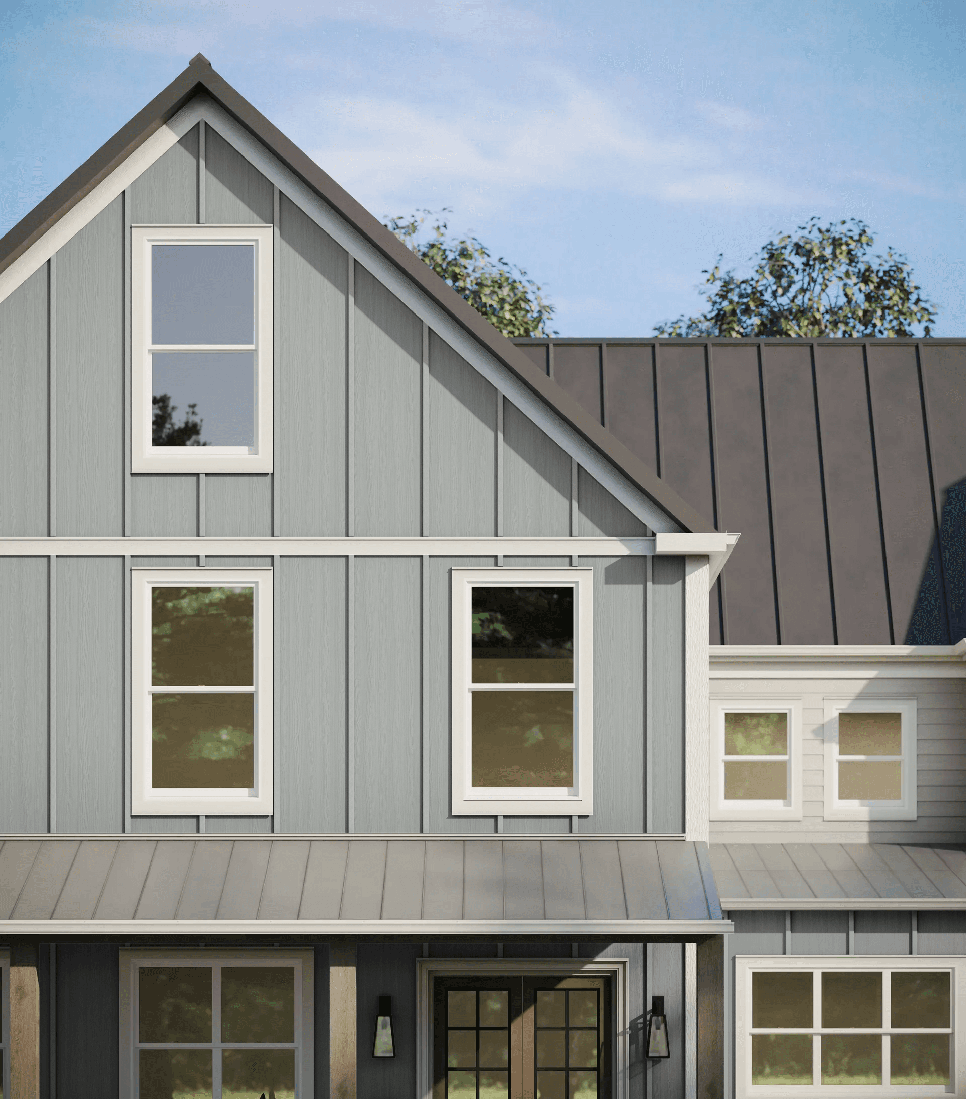 Front view of a modern house with light gray siding and a dark metal roof. Features include large windows and a welcoming entrance under a porch.